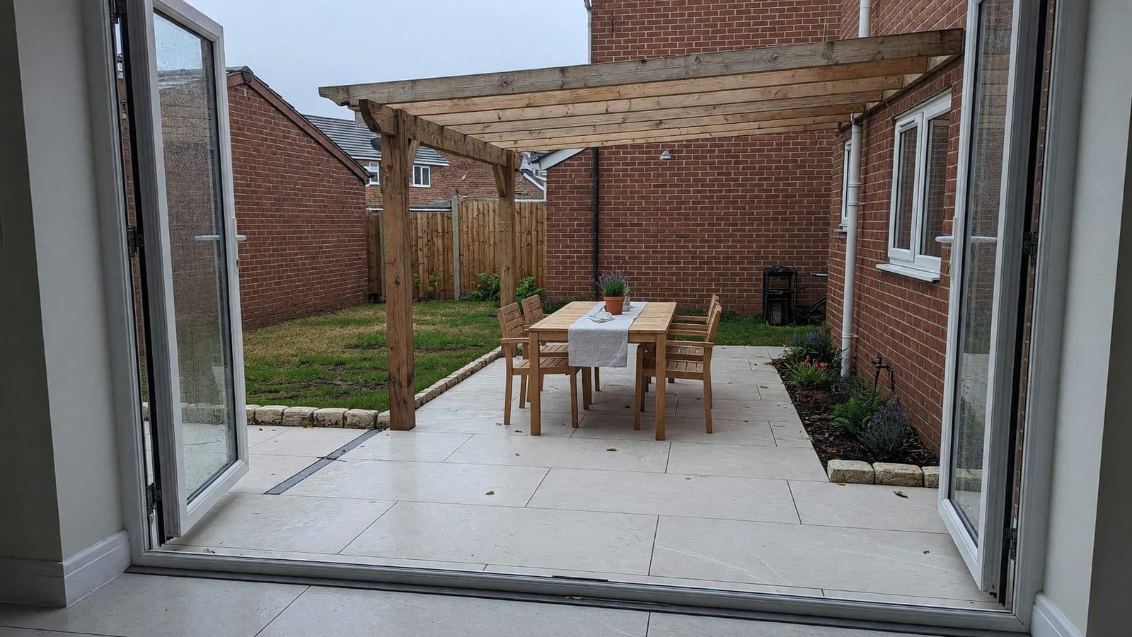 Patio off the kitchen with a pergola over it