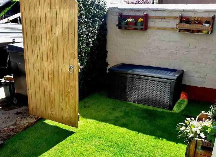 Small garden artificial grass laid on concrete