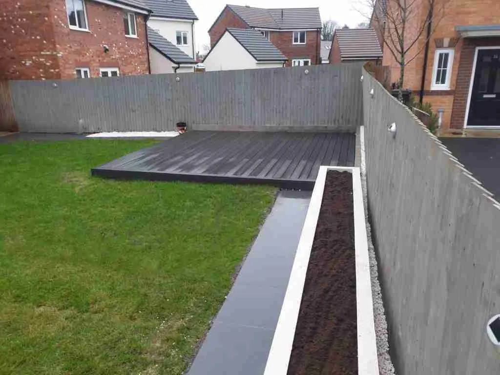 Grey composite decking and grey fence. Landscape gardening Preston