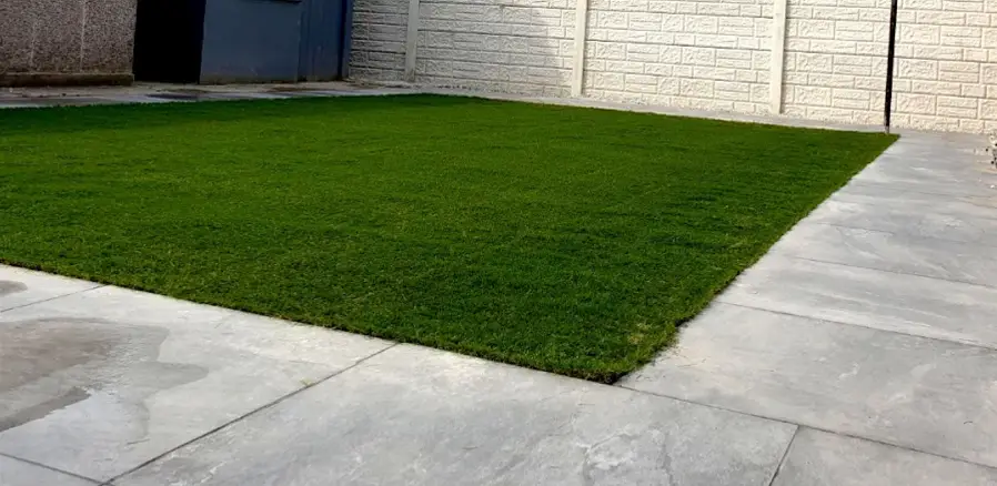 Artificial grass edged with porcelain paving Artificial grass edged with porcelain paving