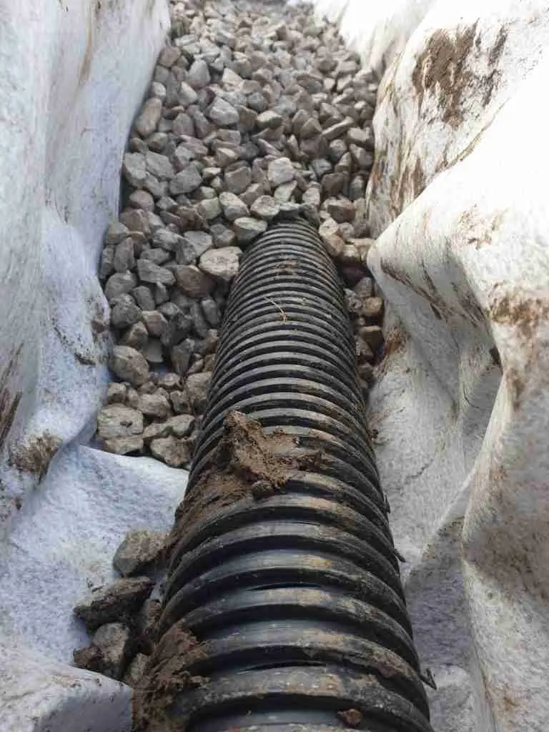 French drains are laid under porous surfaces to collect and redirect water