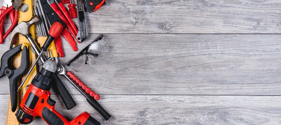 Workman tools on decking to illustrate the labour cost of building decking