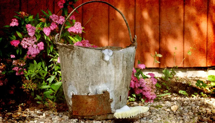 soap bucket next to fence